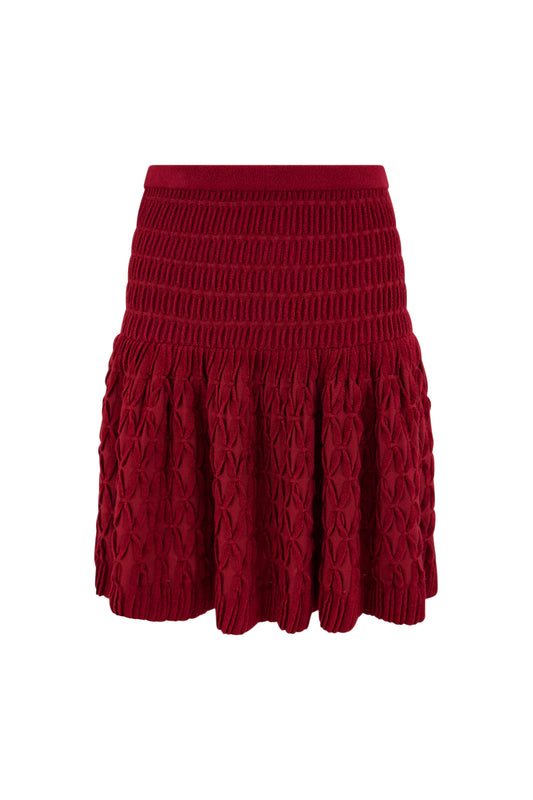 Red Alaïa knit flared skirt with sculpted hem on white background