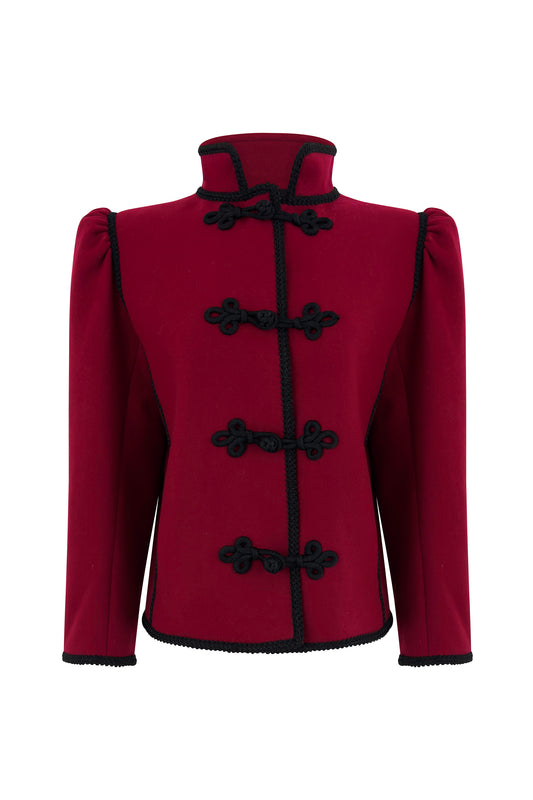 Red YSL wool jacket with black military-style braid closures and high collar on white background