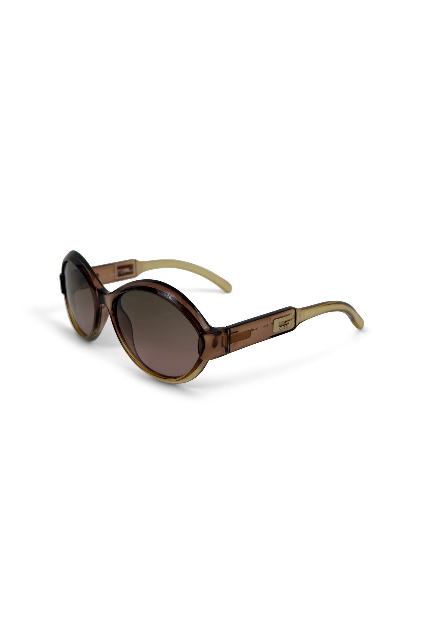 Brown translucent round Gucci sunglasses with gradient lenses on white background
