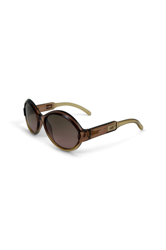 Brown translucent round Gucci sunglasses with gradient lenses on white background