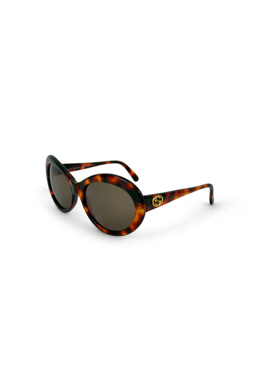 Tortoise oversized rounded cat-eye Gucci sunglasses on white background